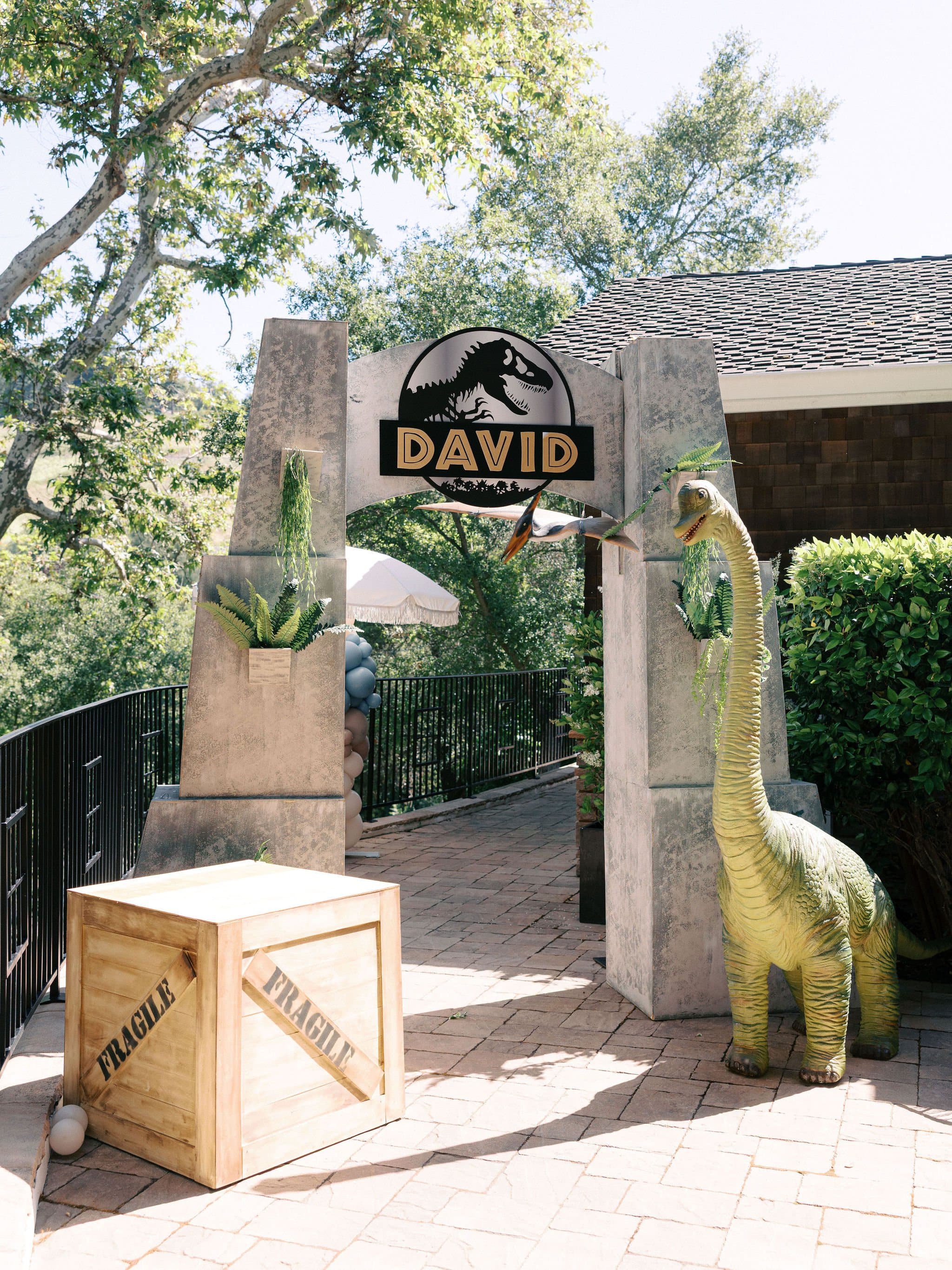 Dinosaur party entrance with a custom name sign